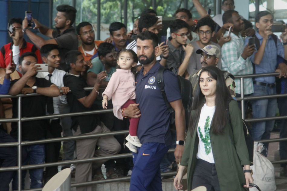 Pujara accompanied by family