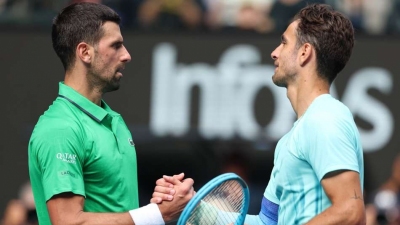 Djokovic scrapes into last four